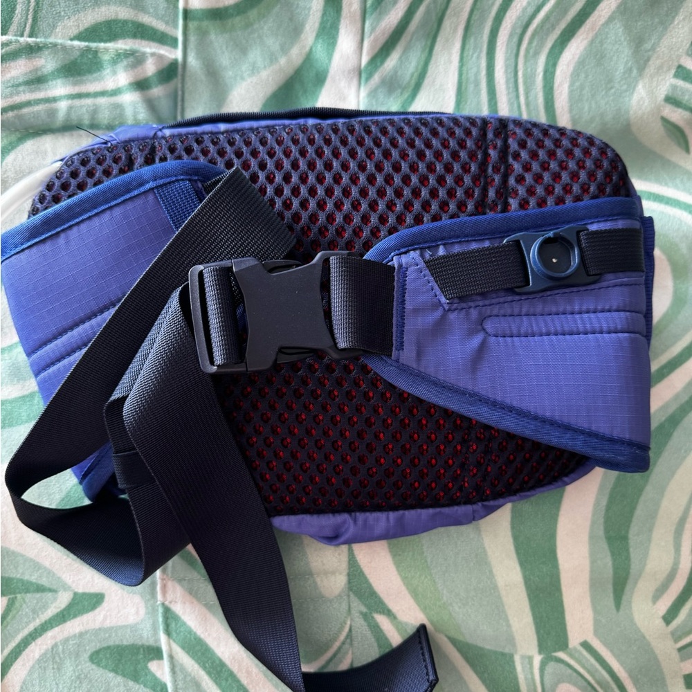 Cotopaxi 2L purple hydro hip pack with red and orange accents. - Picture 2 of 4